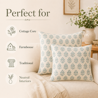 Two decorative throw pillows with a repeating blue-gray damask pattern on a cream background, styled on a beige sofa in a warm, cottage-style room. Text on the left reads 'Perfect for' with icons and labels for Cottage Core, Farmhouse, Traditional, and Neutral Interiors.