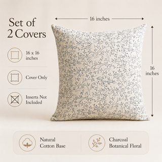A set of two decorative throw pillow covers shown on a warm beige background, with dimension arrows indicating a 16 x 16 inch size. Text on the left notes that the set includes 2 covers, 16 x 16 inch measurements, no inserts are included, and the covers are made from natural cotton with a charcoal botanical floral print.
