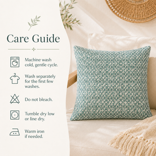 A square throw pillow with a teal and white floral pattern sits on a beige sofa next to a care guide panel detailing how to wash and dry it.
