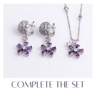 Jewelry set with purple gemstones on a white background