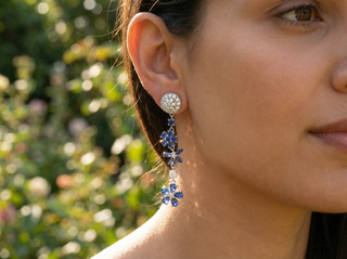 Close-up of a woman wearing a sparkling earring with a blurred green background