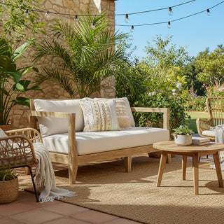 Outdoor patio with wooden sofa, table, and decorative elements in a garden setting.