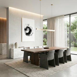 Modern dining room with a long wooden table and chairs, featuring a abstract painting on the wall.