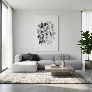 Modern living room with a gray sectional sofa, coffee table, and abstract art on the wall.