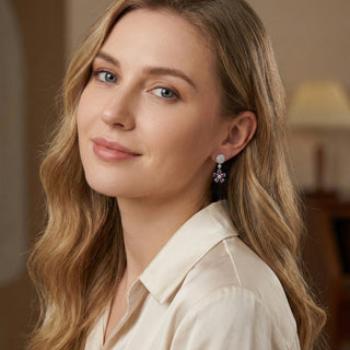 Woman wearing earrings with a blurred indoor background