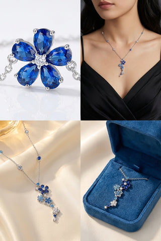 Blue gemstone jewelry set including earrings, necklace, and pendant on a white background.