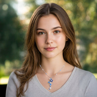 Woman wearing a necklace with a blurred green background