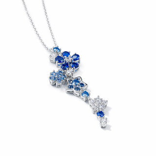 Silver necklace with blue gemstones on a white background