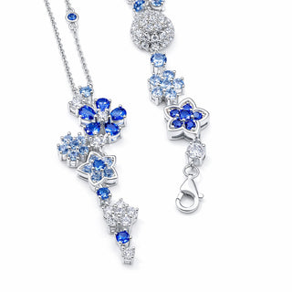 Silver necklace with blue gemstones on a white background