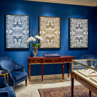 Decorative room with blue walls, framed artwork, and furniture.