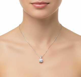 Silver necklace with a diamond pendant on a model against a white background