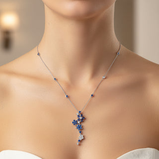 Necklace with blue and white gemstones on a model against a neutral background