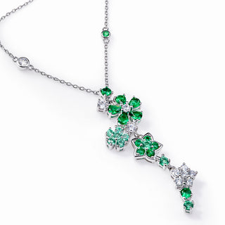 Elegant necklace with green gemstones on a white background