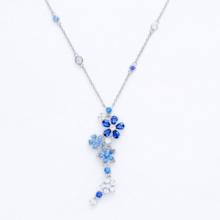 Silver necklace with blue gemstone pendant on a white background