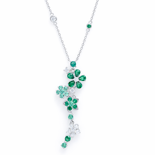 Emerald and diamond necklace on a white background